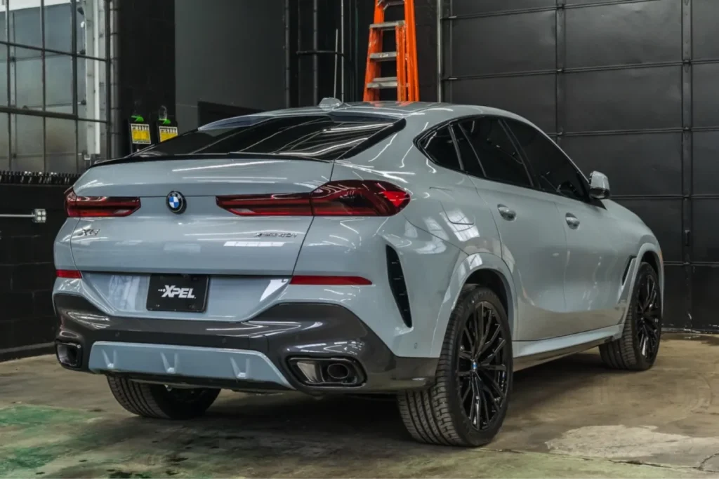 A car with tinted windows parked inside a garage.
