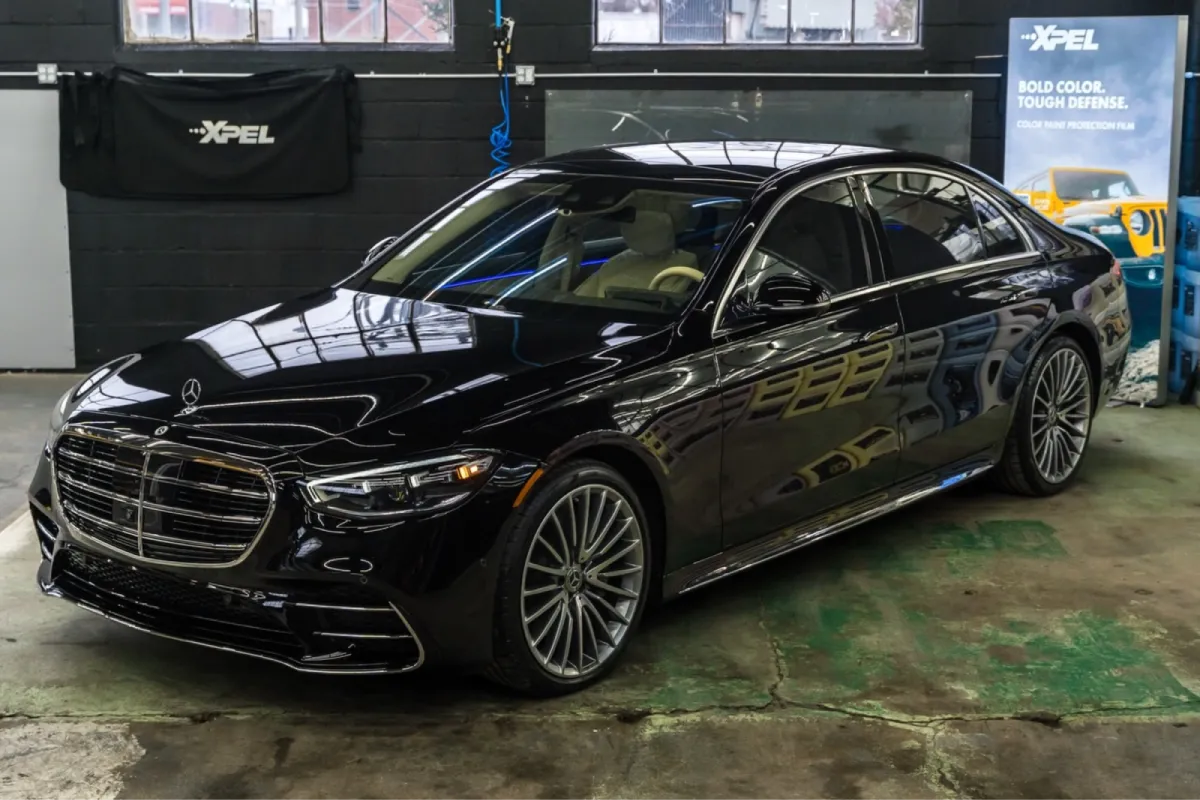 Front view of a black Mercedes-Benz sedan with a shiny finish.