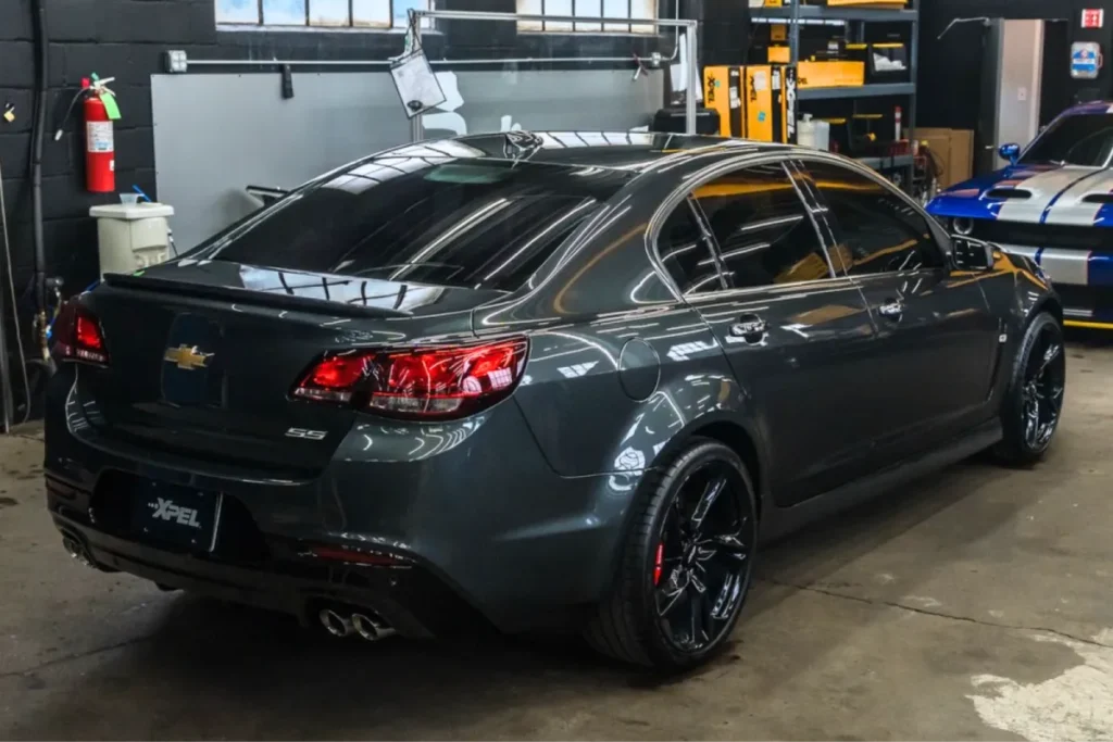 Gray Chevrolet SS sedan with window tint parked in detailing shop