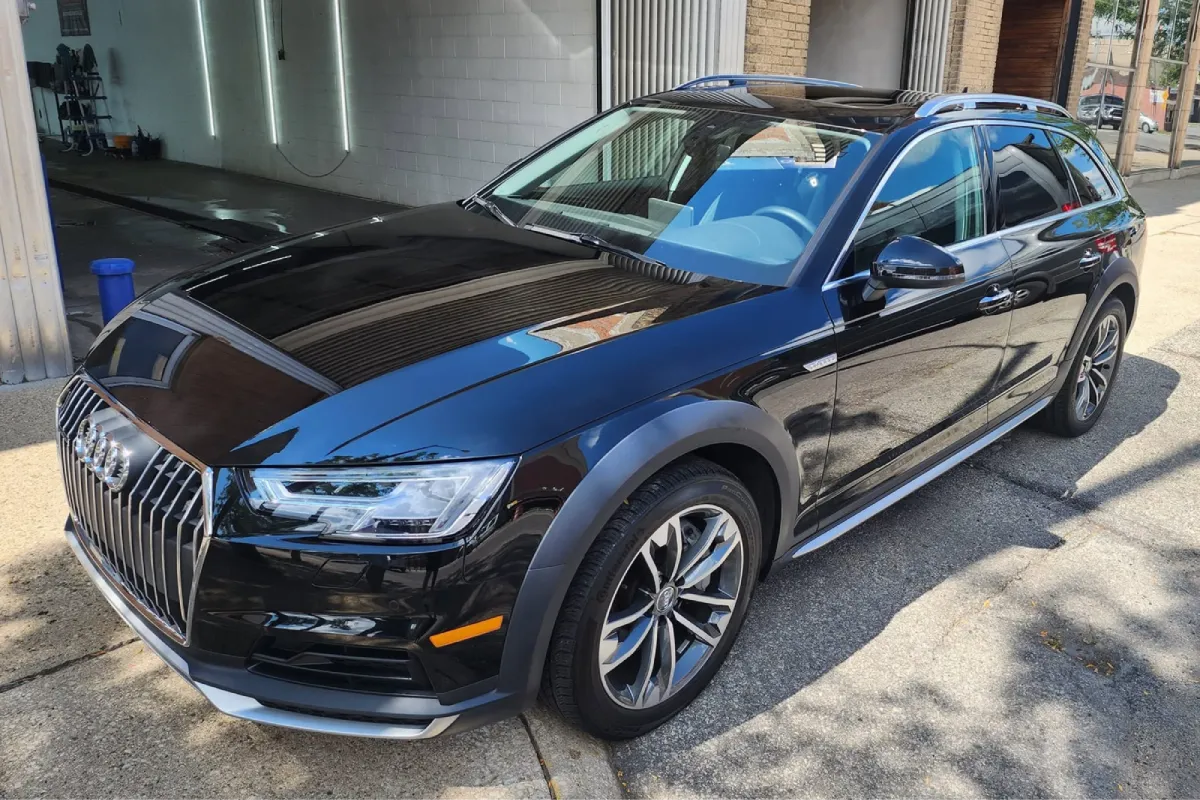 Paint protection film applied on a black Audi SUV, delivering a high gloss finish and surface protection.